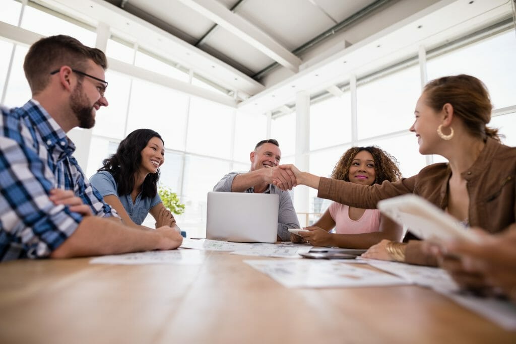 Executives shaking hands in the meeting at office