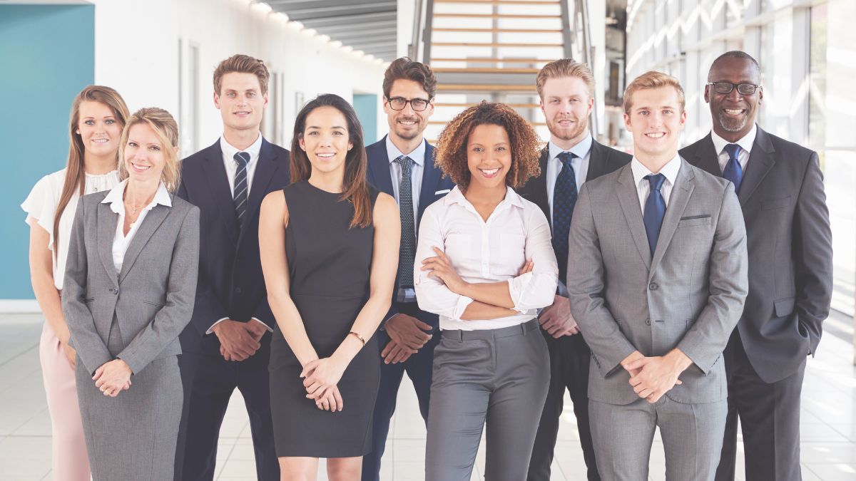 Group of SMB workers in business clothing smiling at camera