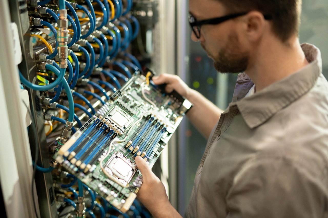 MSP systems engineer inspecting server motherboard